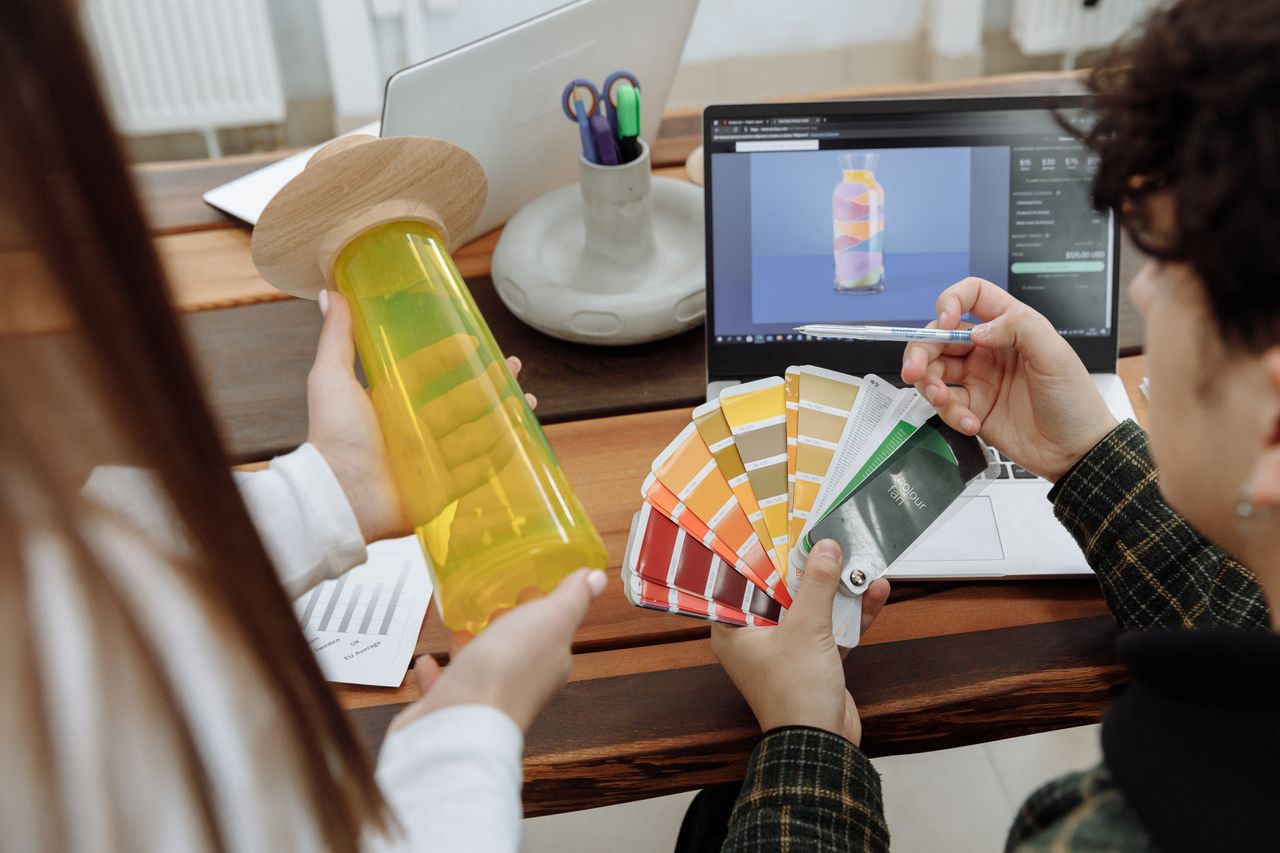 Crafting Captivating Headlines: Your awesome post title goes here Designers collaborating with color swatches and digital mockups in a modern workspace.